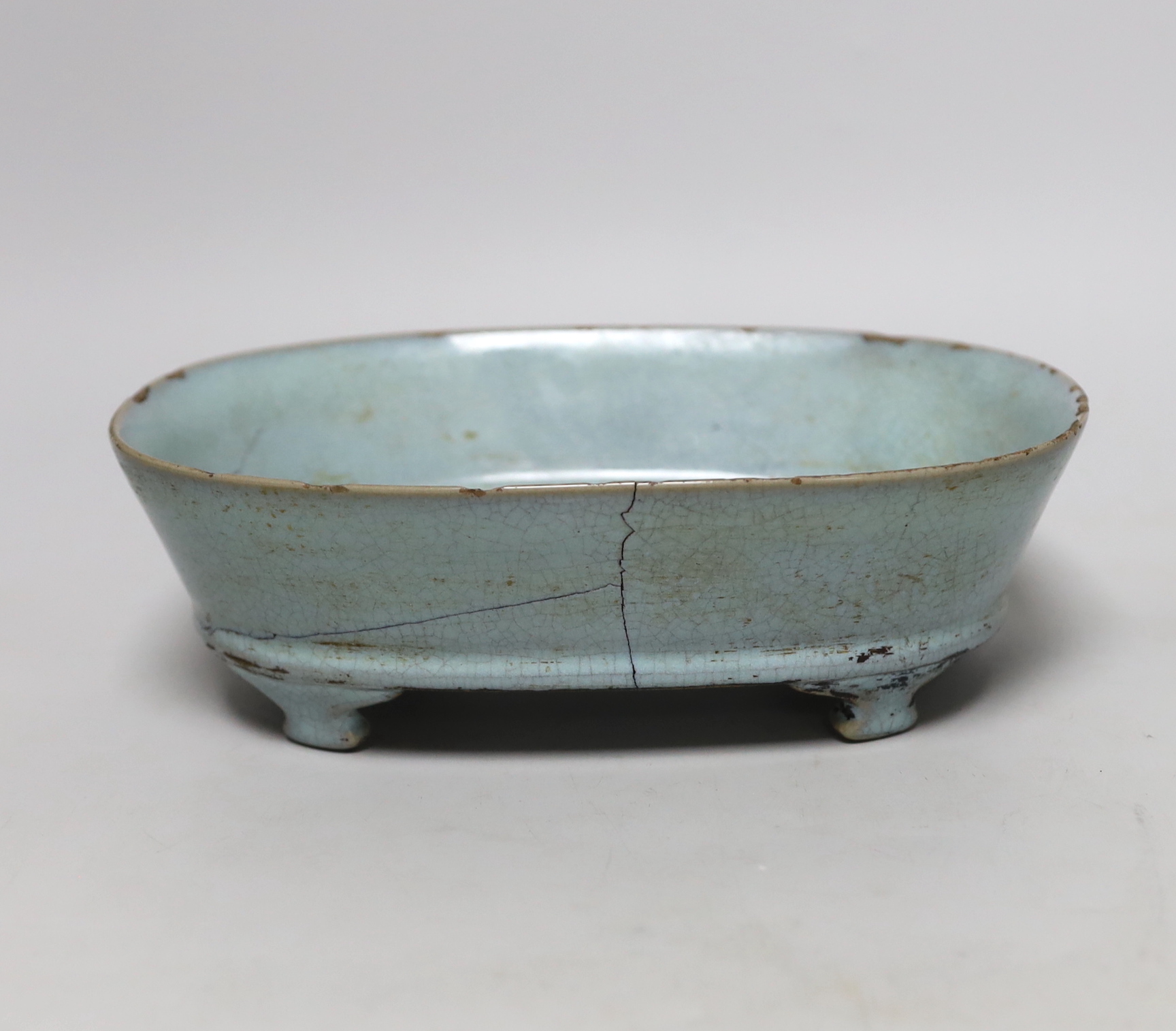 A Chinese celadon crackle glazed oval dish, 23cm wide